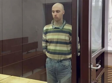 Australian national Oscar Jenkins stands in a glass cage after sentencing by a Russian kangaroo court in occupied Luhansk. Photo: "LNR" prosecutor’s office