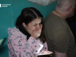 A Ukrainian woman is crying after she survived the Russian attack on her apartment building in Kharkiv on 11 June.
