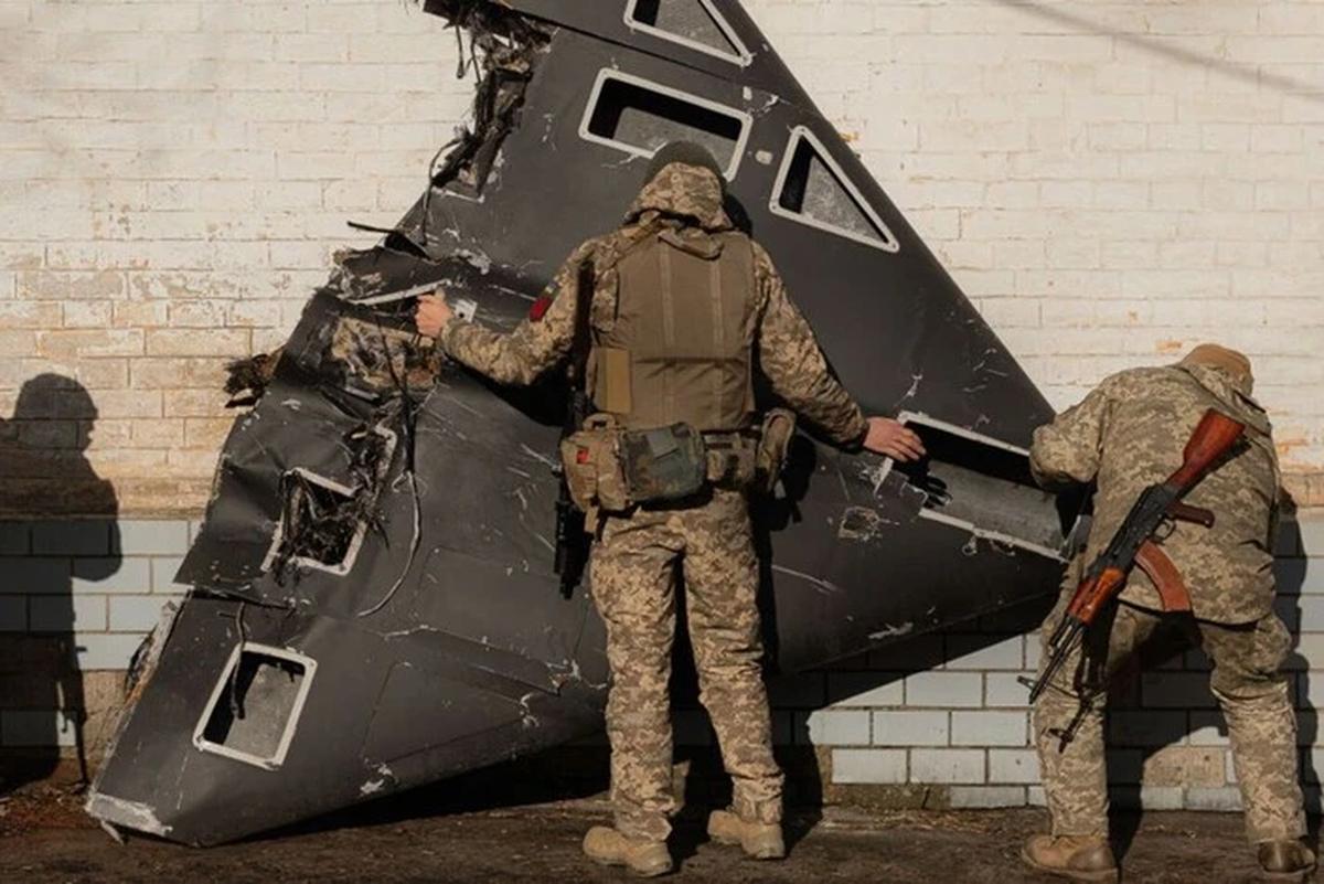 two russian drones cross nato airspace again — poland says it’s fine response needed ukrainian soldiers stand near downed shahed-136 kamikaze drone shahed shot down1 violations came same night russia